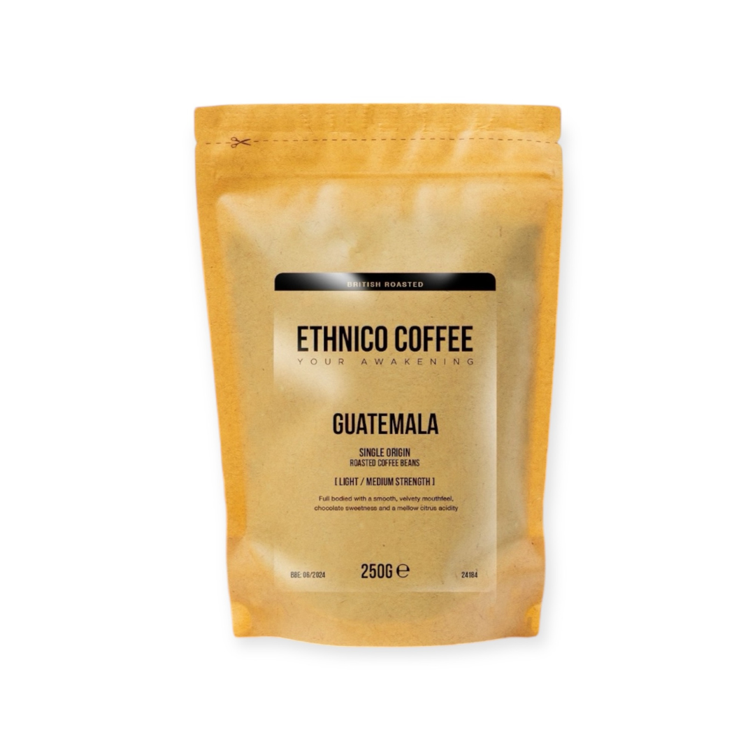 250g bag of Ethnico Guatemalan coffee beans alongside brewing equipment, showcasing fresh roasted specialty coffee for espresso, French press, or pour-over.